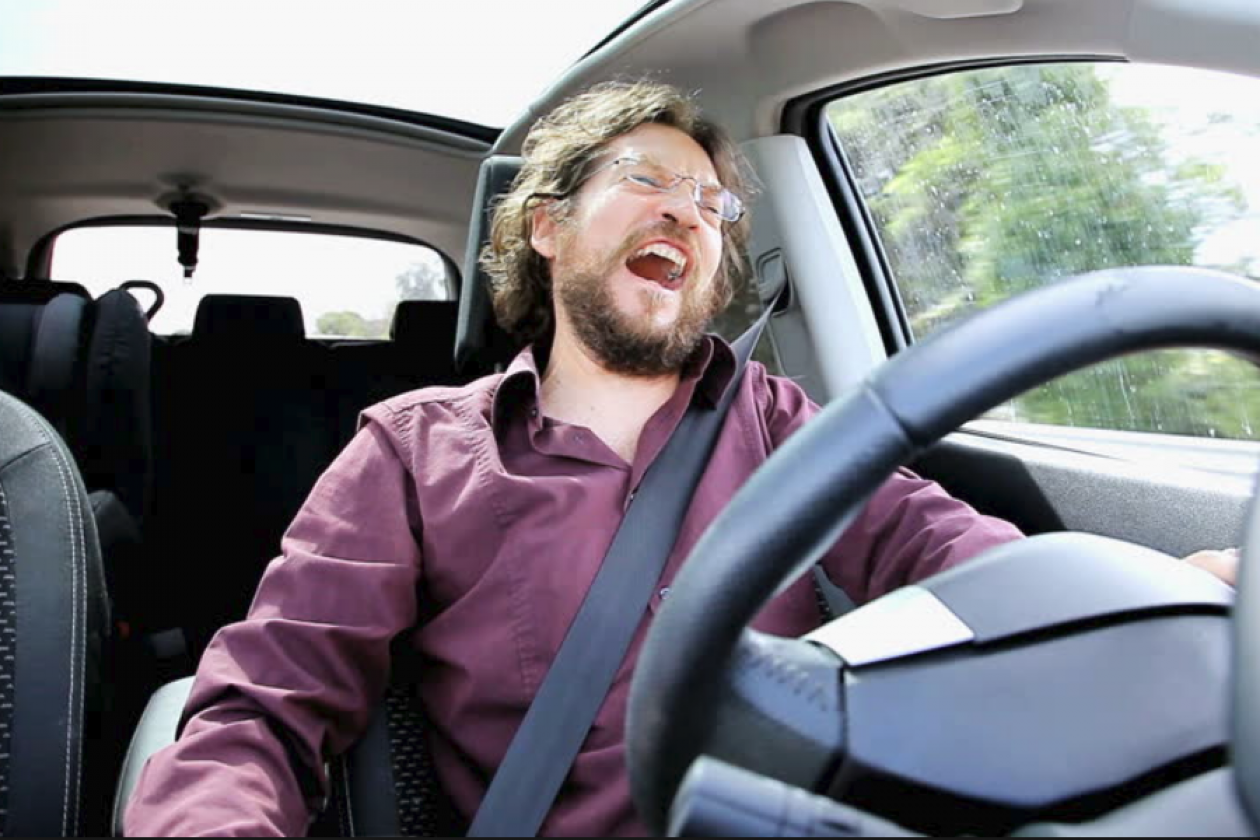 The owner of the car аудирование. Man laughing in the car. He is Driving a car. Man Driving fast.